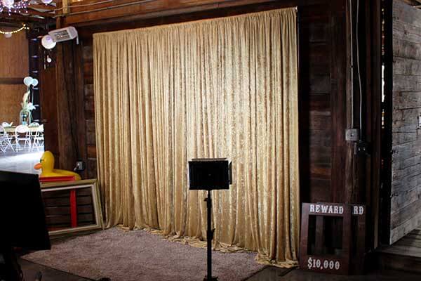 Gold fabric rustic event photo booth rental