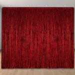 Red fabric solid color draped wedding and party backdrop.